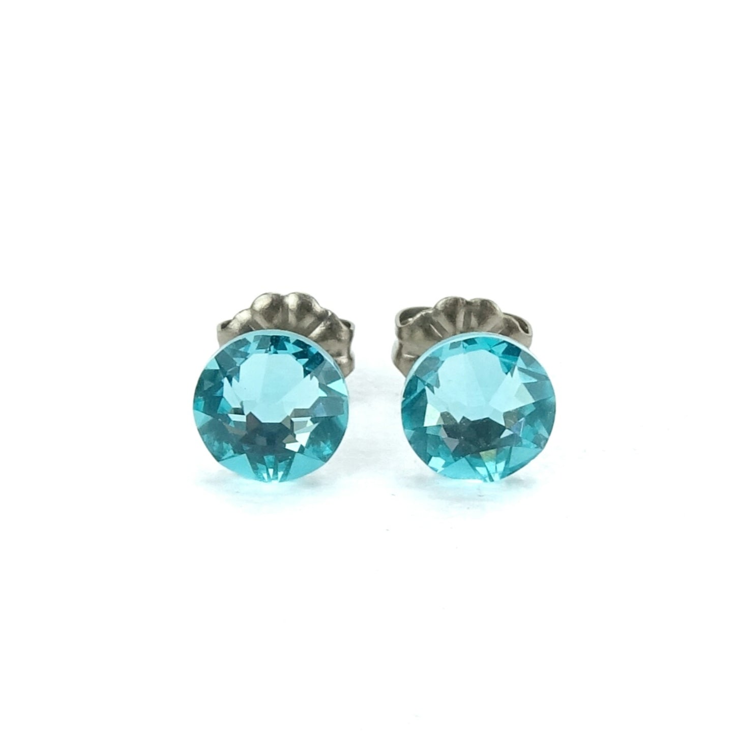 A pair of turquoise-colored earrings with a silver post.