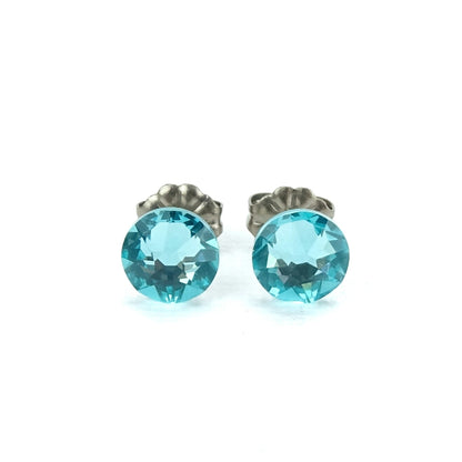 A pair of turquoise-colored earrings with a silver post.