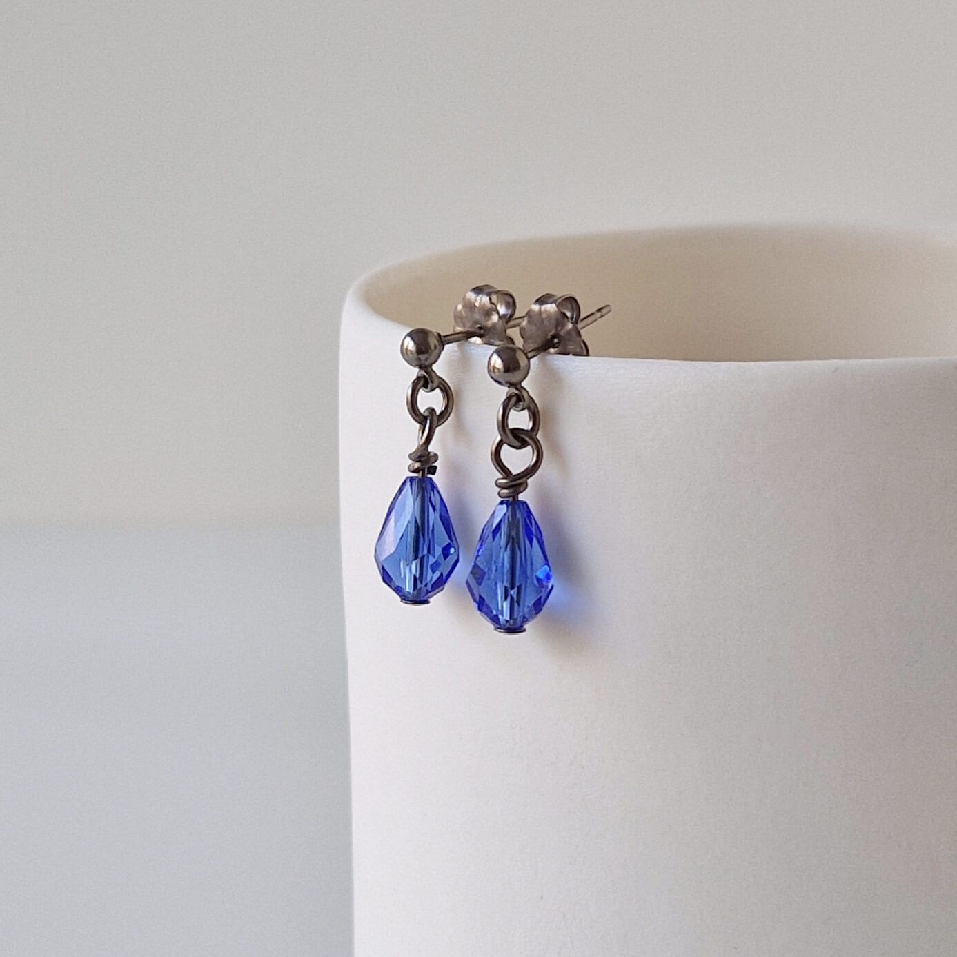 Titanium Stud Earrings with Dangling Sapphire Blue Crystal Teardrops