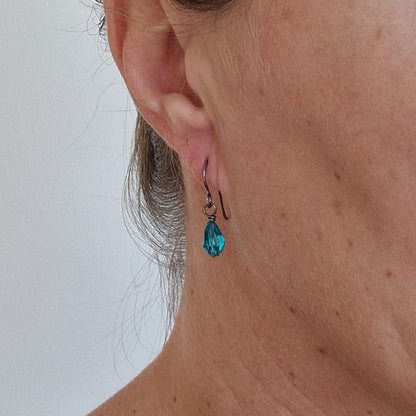 Pure Titanium Earrings with Blue Zircon Crystal Teardrops Shown in Ear