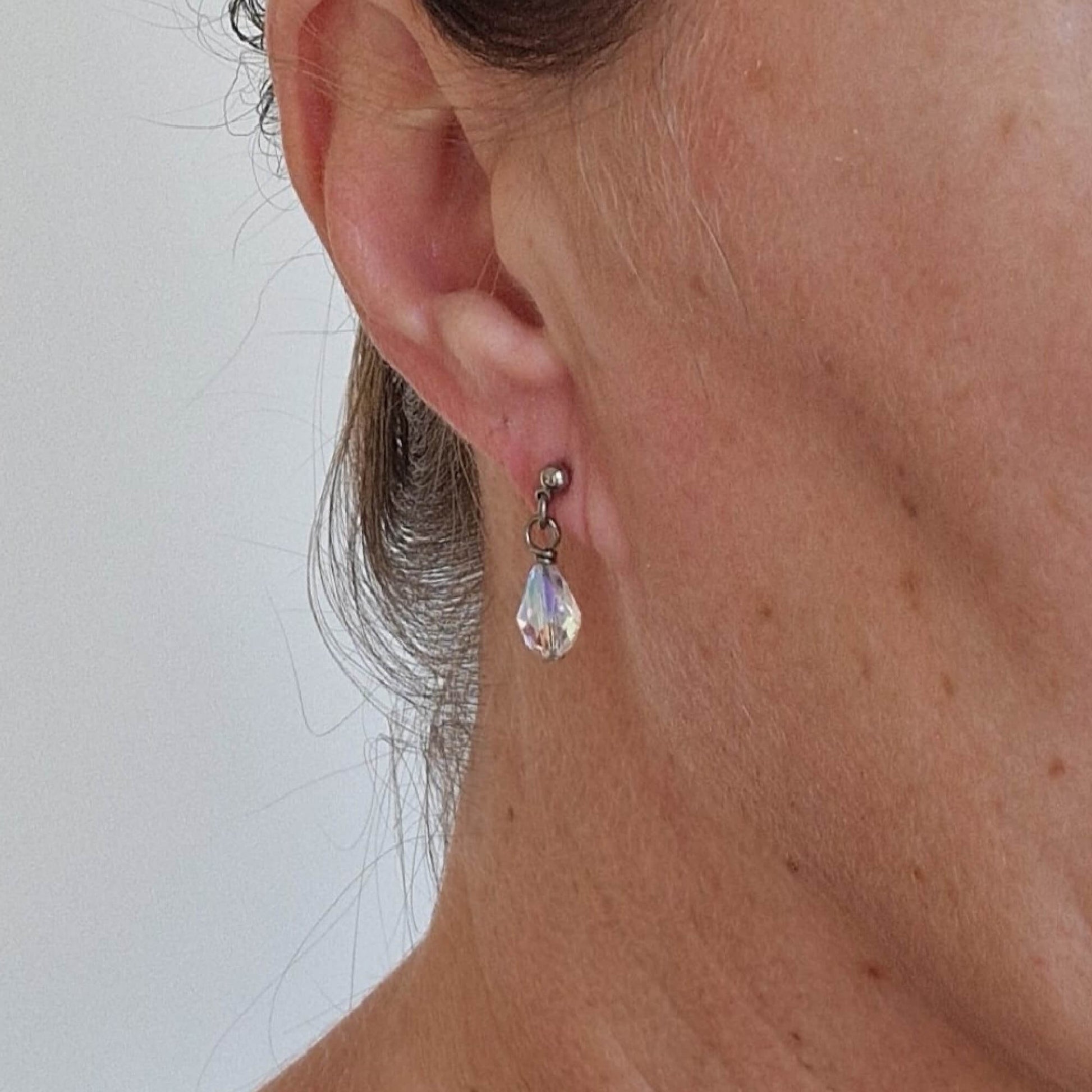 Titanium Stud Earrings with Dangling Crystal Shimmer Teardrops Shown on Ear